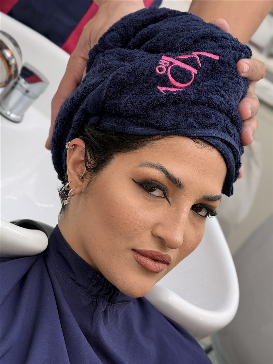 Salon client wearing the KPV Pro towel at the wash basin